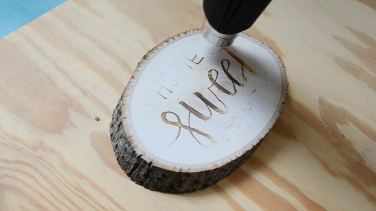 Torch the wooden plank using the electric heat gun and be patient; otherwise, you will end up burning the wood.