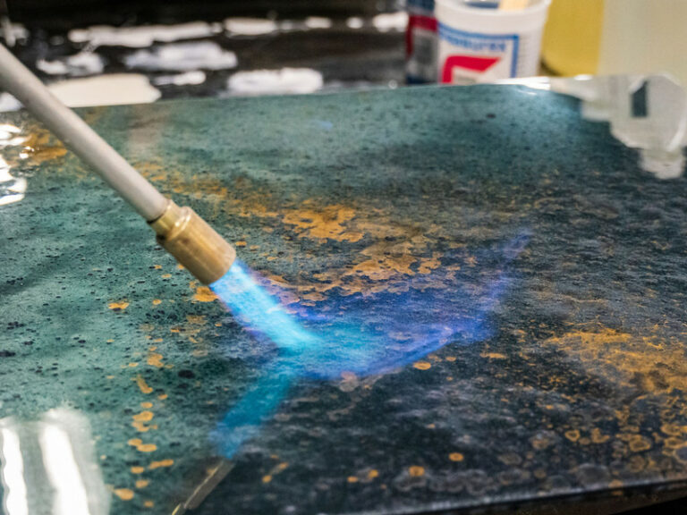 Use an epoxy detail torch to blow bubbles on the surface of the wooden plank.