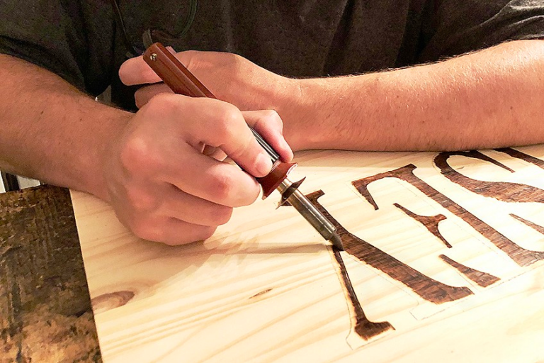 Use wood burning tool for burning alphabets on wood